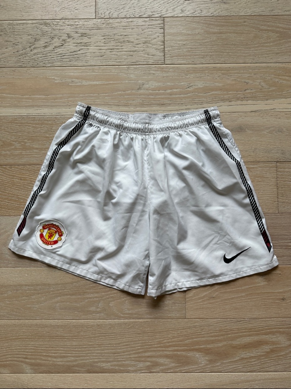Mens Nike Dri Fit White Soccer Shorts with Black Trim and Manchester United Logo